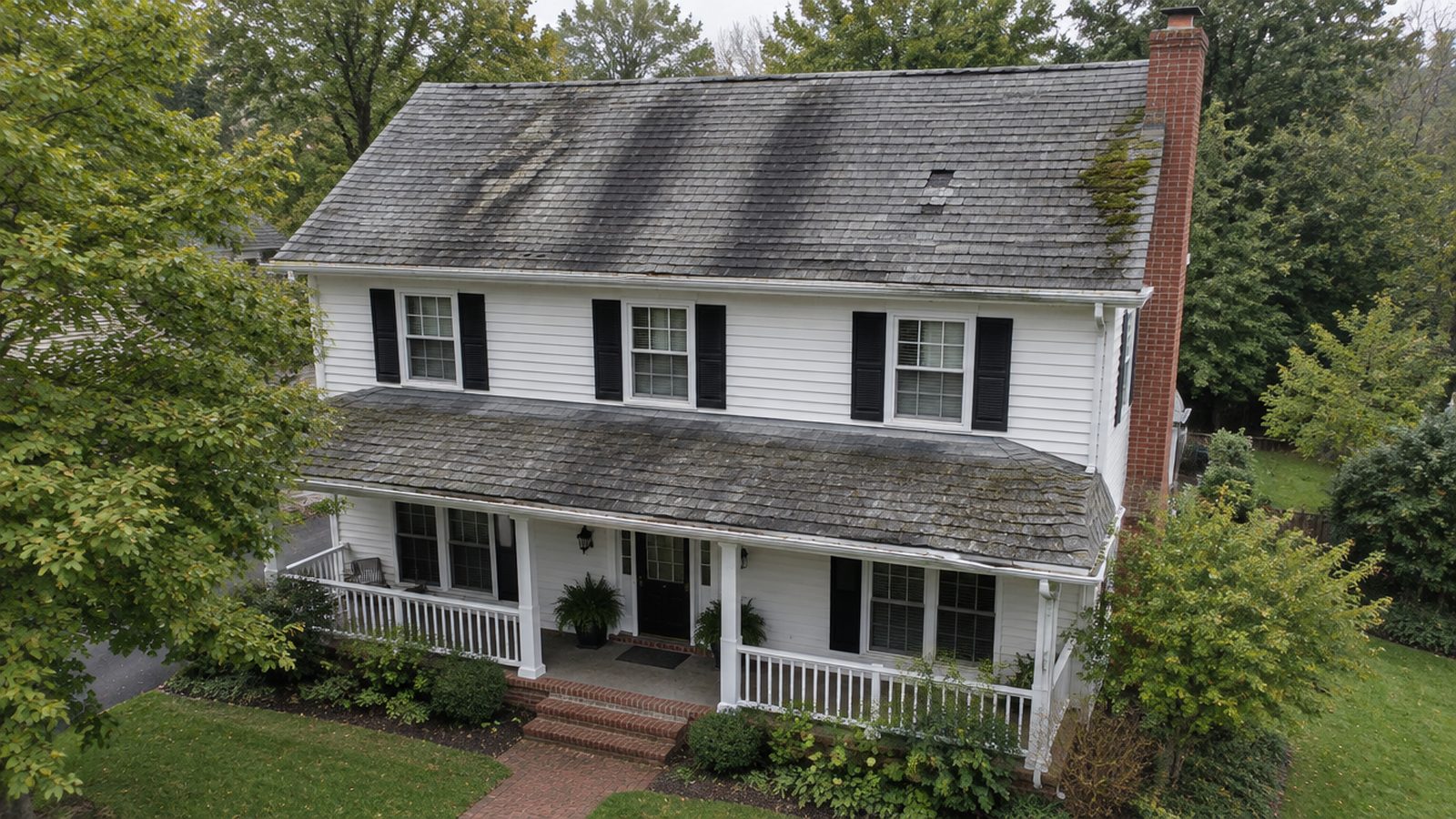 House before: stained, mossy, failing roof